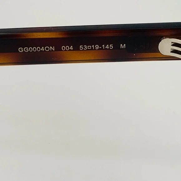 Gucci's GG0004ON features soft lines frames acetate front. Iconic web effect